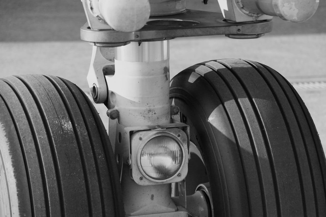 Detailed monochrome image showcasing the landing gear of an aircraft.