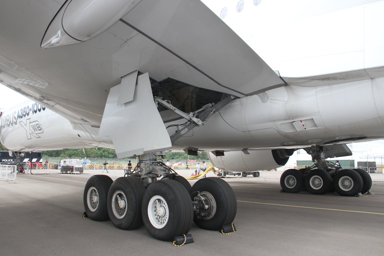 Close-up of an Airbus A350-1000s landing gear while parked on a tarmac.